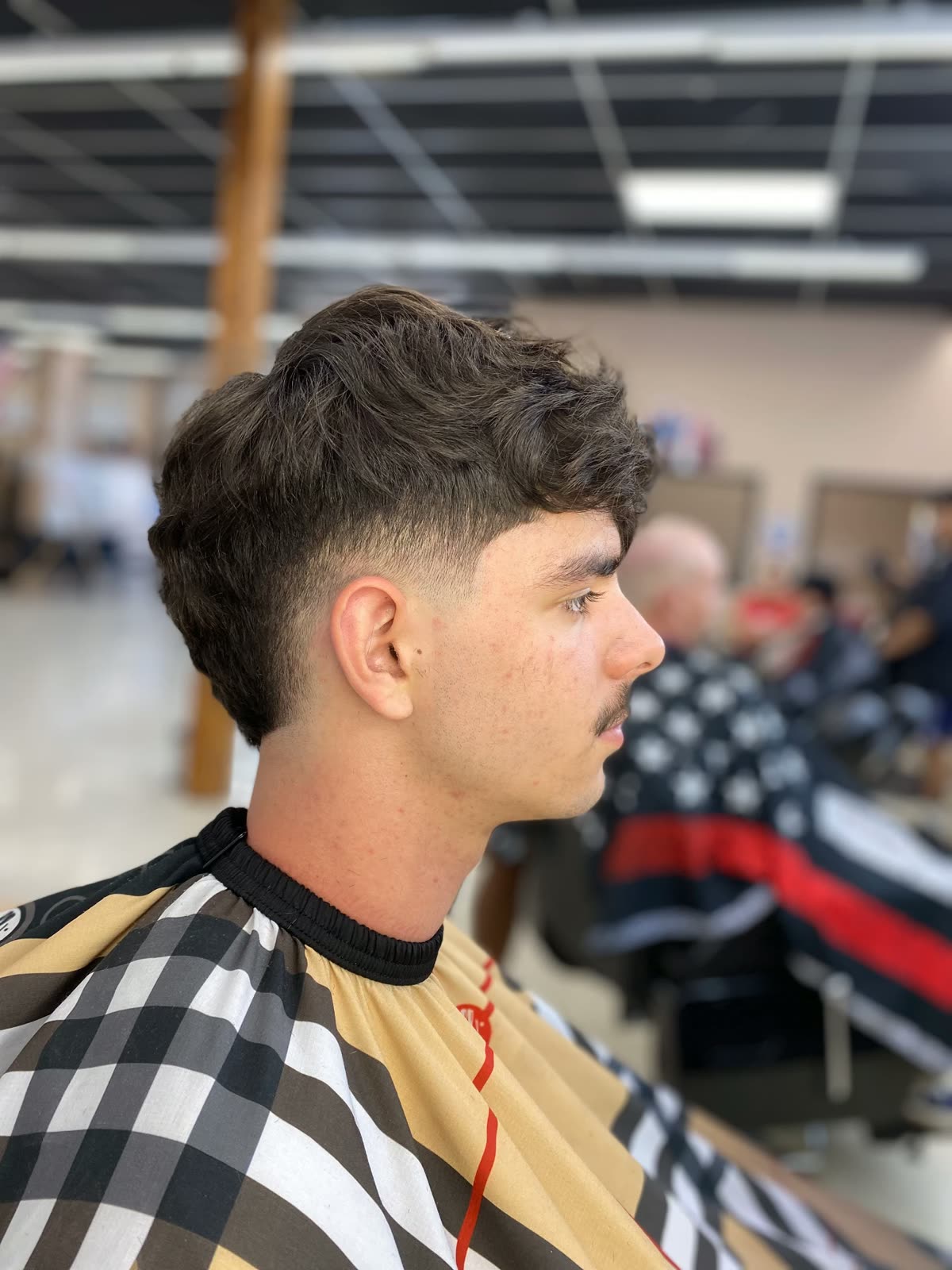 Textured wavy cut with a low taper
